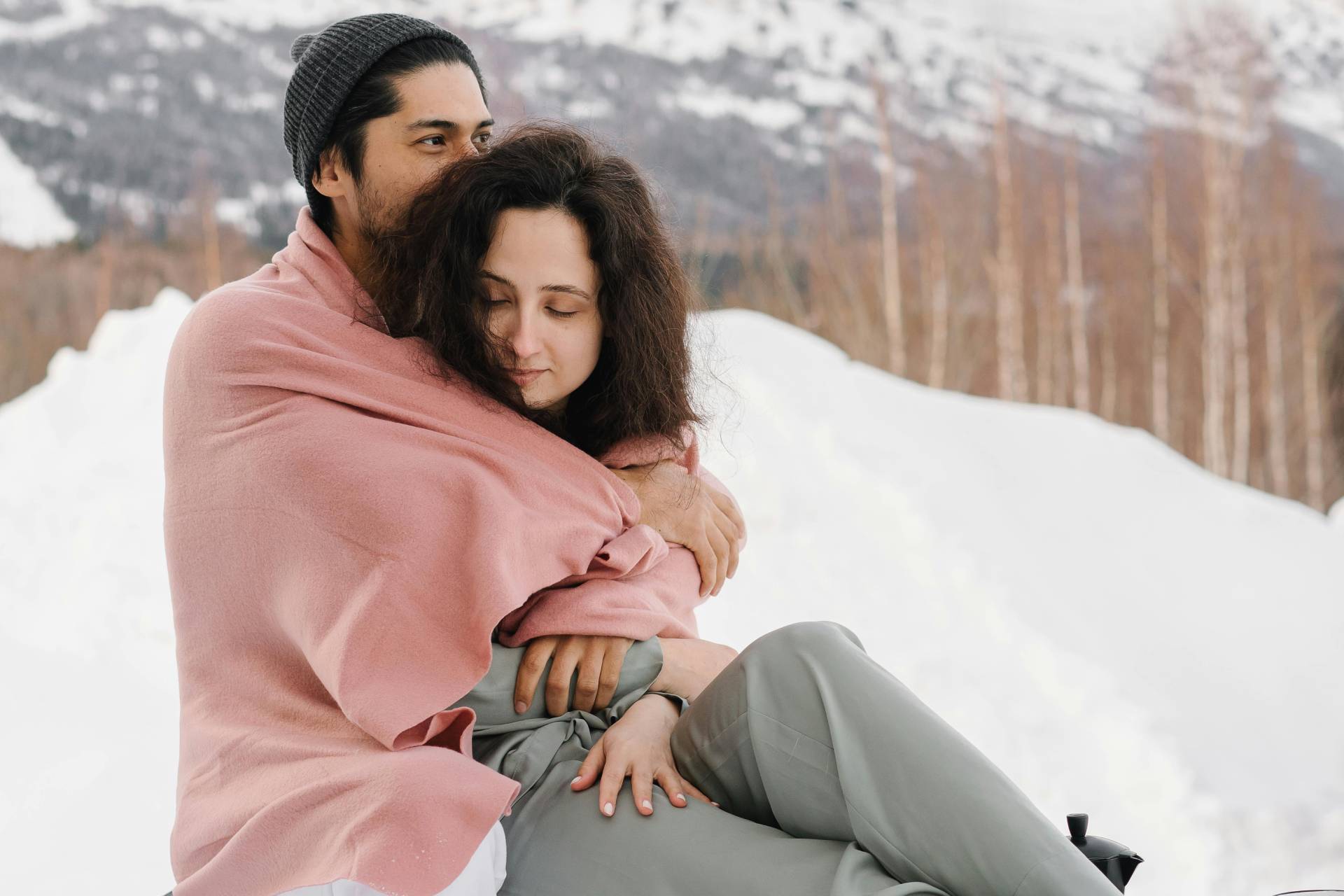 a man hugging a woman in the snow