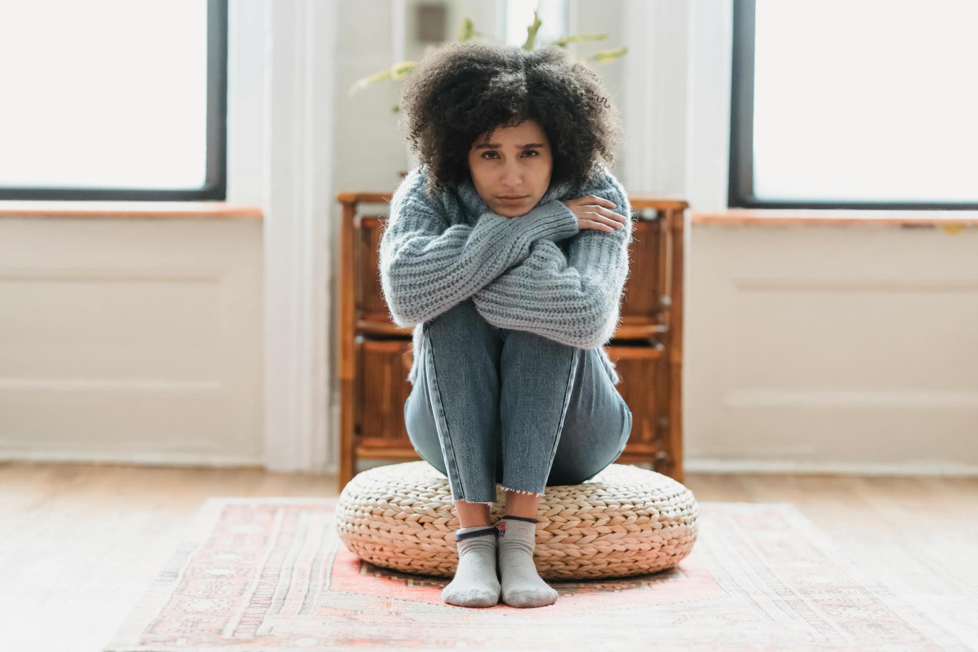 Stressed woman sitting on the ground