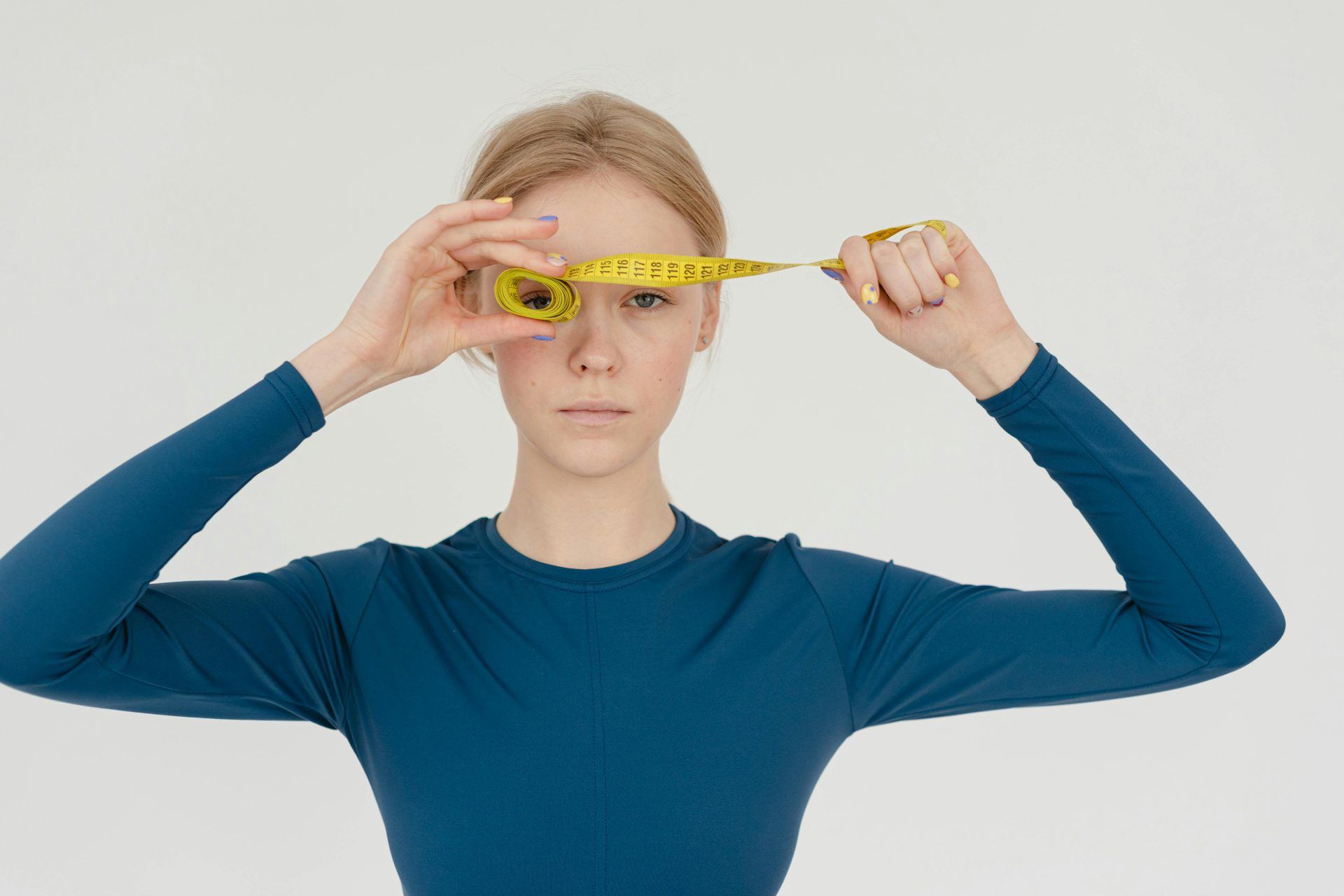 Girl in blue top with measuring tape