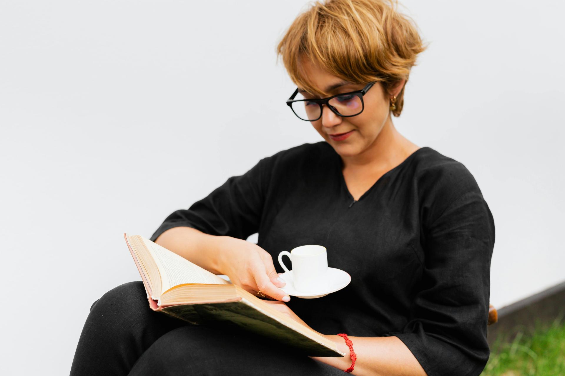 woman in black top reading book