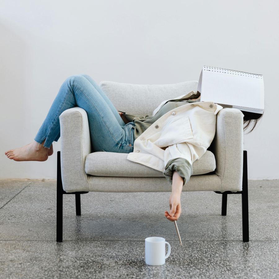 Girl lying on a chair with book on her face