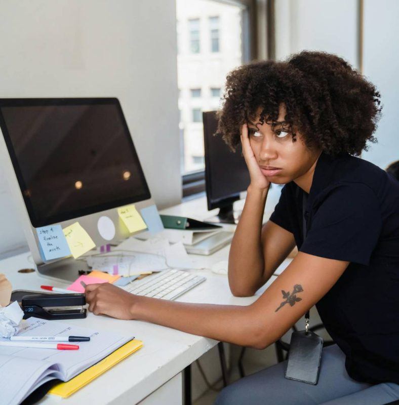 a woman sitting at a desk in front of a computer
